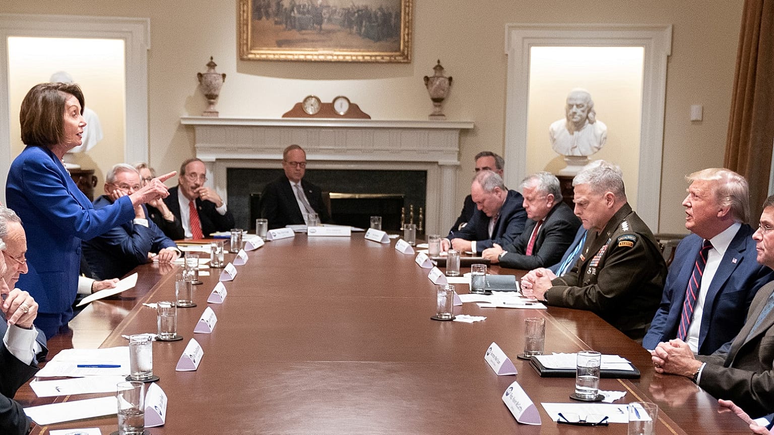 Speaker of the House Nancy Pelosi stands and speaks to President Trump during Syria meeting in photo released by White House in Washington