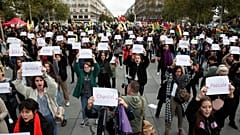People attend a demonstration against femicide and violence against women at Place de la Republique in Paris
