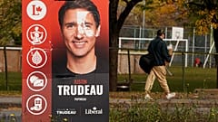 A man walks past a Justin Trudeau sign in the Papineau area of Montreal, Quebec, Canada October 20, 2019. 