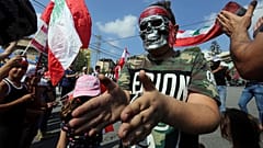 A demonstrator wearing a mask takes part in an anti-government protest in the southern city of Nabatiyeh, Lebanon October 21, 2019.