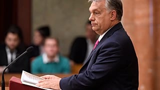 Hungarian opposition MP holds 'lies' sign during Orban's parliament speech