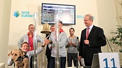 FILE PHOTO: Belgian athlete Marieke Vervoort rings a bell in the presence of fellow athletes, 2012s