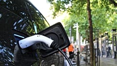 An electric car charges at a roadside charging point