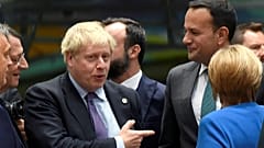 Britain's Prime Minister Boris Johnson, Ireland's Taoiseach Leo Varadkar and  German Chancellor Angela Merkel talk as they attend the European Union leaders summit in Brussels