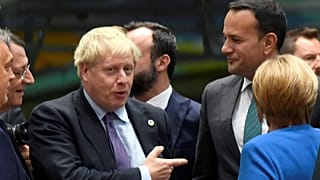 Britain's Prime Minister Boris Johnson, Ireland's Taoiseach Leo Varadkar and  German Chancellor Angela Merkel talk as they attend the European Union leaders summit in Brussels