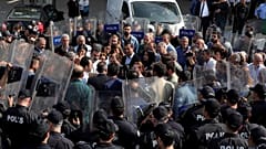 Pro-Kurdish Peoples' Democratic Party (HDP) lawmakers are surrounded by riot police as they protest against detention of their local politicians in Diyarbakir, Turkey