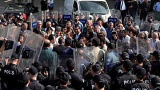 Pro-Kurdish Peoples' Democratic Party (HDP) lawmakers are surrounded by riot police as they protest against detention of their local politicians in Diyarbakir, Turkey