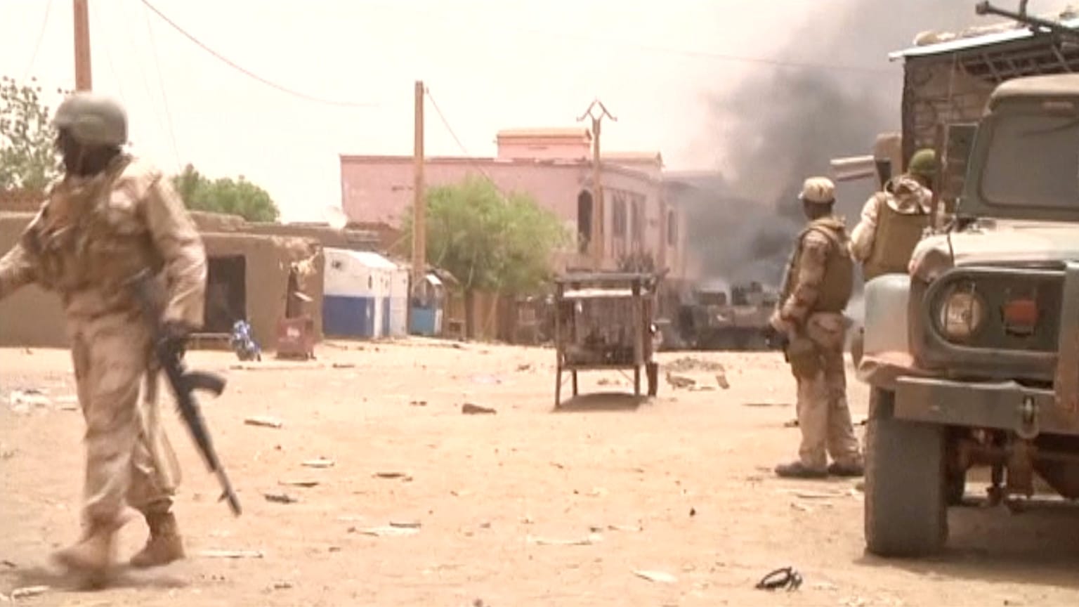 FILE:  Soldiers stand guard as smoke rises in the distance after a car bomb attack in Gao, northern Mali July 1, 2018. 