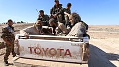 FILE PHOTO: Three men that Democratic Forces of Syria fighters claimed were jihadist fighters sit on a pick-up truck while being held as prisoners, Syria, February 18, 2016 