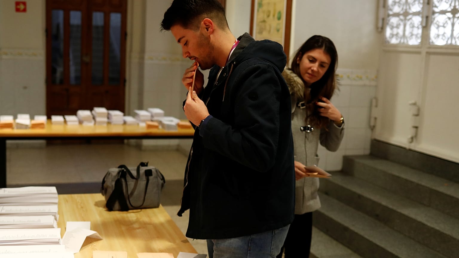 People pick up ballots as they prepare to vote during general election in Madrid, Spain, November 10, 2019. 