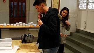 People pick up ballots as they prepare to vote during general election in Madrid, Spain, November 10, 2019. 