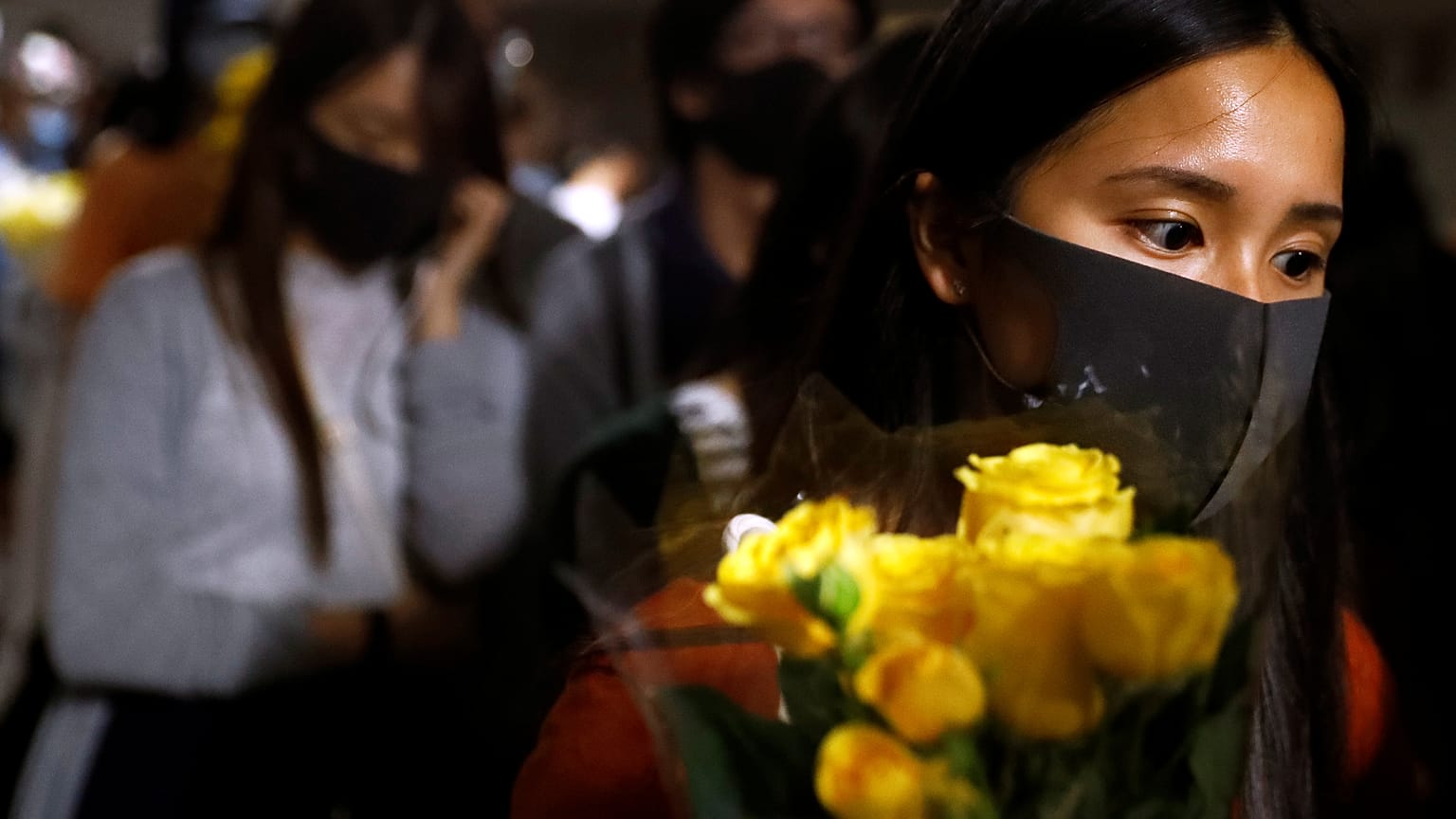 A woman pays tribute with flowers to Chow Tsz-lok, 22, a university student who died after he fell during a protest in Hong Kong, China, November 8, 2019. 
