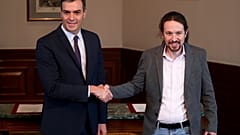 Spanish acting Prime Minister Pedro Sanchez and Unidas Podemos (Together We Can) leader Pablo Iglesias shake hands during a news conference at Spain's Parliament in Madrid