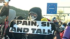 Police face off against protesters on France-Spain border