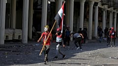 أحد المتظاهرين يحمل العلم العراقي خلال الاحتجاجات المناهضة للحكومة في بغداد، العراق في 7 نوفمبر/ تشرين الثاني 2019