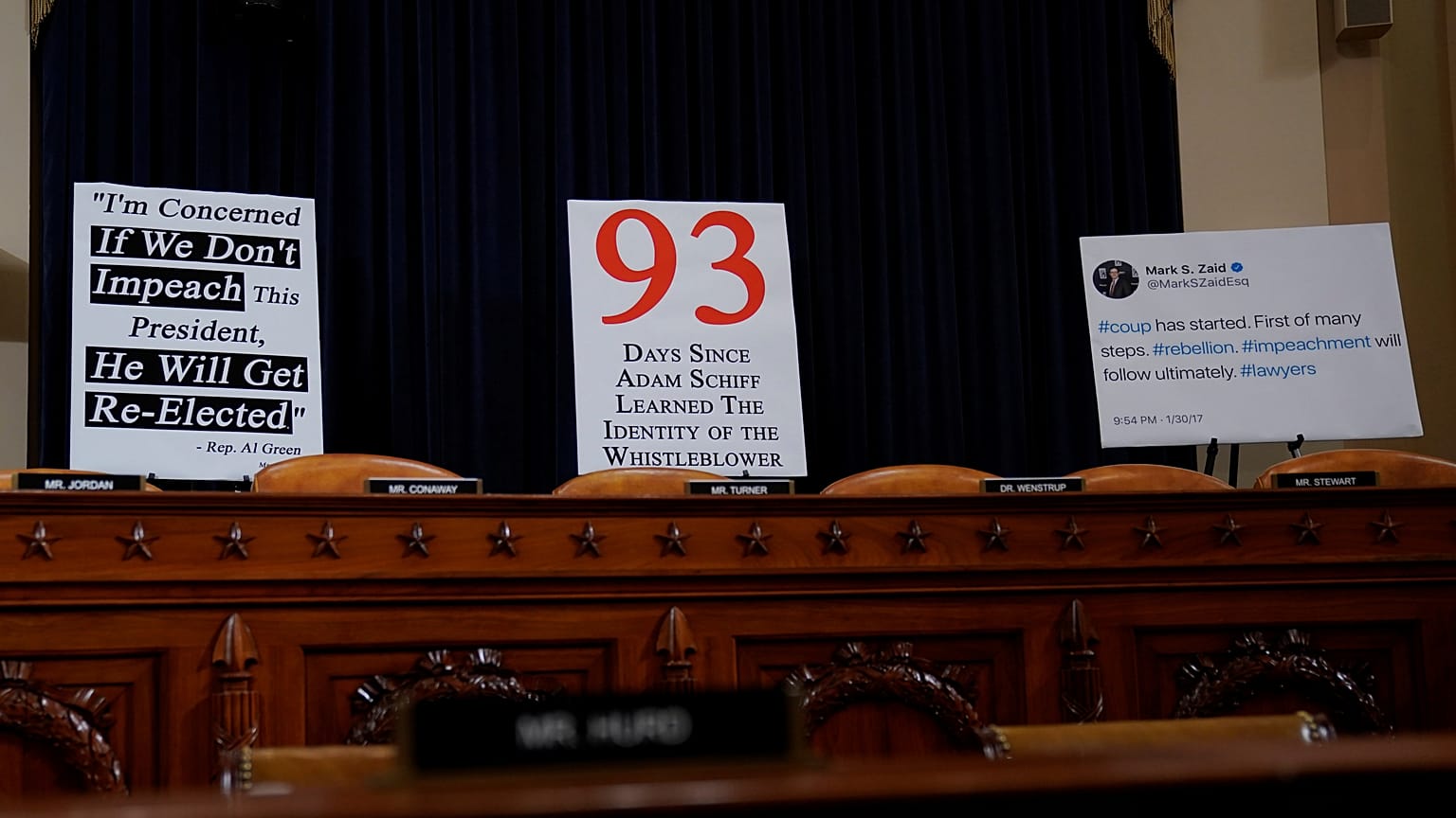 Signs are placed behind seats of committee members at a House Intelligence Committee hearing as part of the impeachment inquiry into U.S. President Donald Trump 