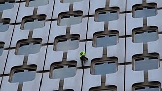 'French Spider-Man' Alain Robert scales Paris skyscraper as police watch on