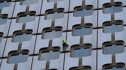 'French Spider-Man' Alain Robert scales Paris skyscraper as police watch on