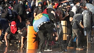 المتظاهرون يحتمون خلف الدروع أثناء احتجاج ضد حكومة تشيلي في سانتياغو، تشيلي 14 نوفمبر/ تشرين الثاني، 2019