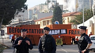 French police stand guard as Greenpeace activists block the entrance of the Total biodiesel refinery at La Mede near Fos-sur-Mer, France October 29, 2019.