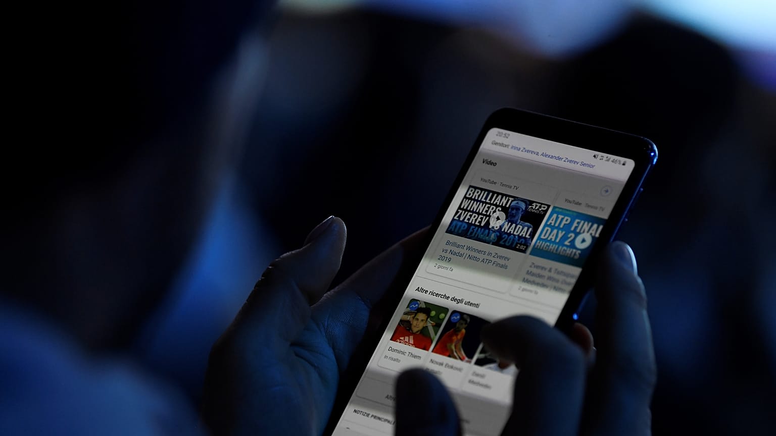 FILE PHOTO: November 13, 2019 A spectator looks at his mobile phone during Tennis - ATP Finals 