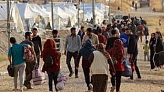 Syrian displaced families, who fled violence after the Turkish offensive in Syria, are seen upon arrival at a refugee camp in Bardarash on the outskirts of Dohuk, Iraq October