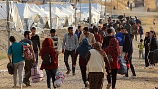 Syrian displaced families, who fled violence after the Turkish offensive in Syria, are seen upon arrival at a refugee camp in Bardarash on the outskirts of Dohuk, Iraq October