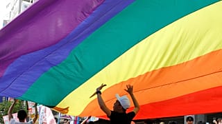 Participants march under a giant rainbow flag during the LGBT Pride parade in Taipei, Taiwan