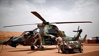French soldiers work on a Tiger attack helicopter at the Operational Desert Plateform Camp (PfOD) during the Operation Barkhane in Gao, Mali, August 1, 2019. 