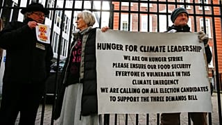 Activists affiliated with Extinction Rebellion take part in a hunger strike outside of the Conservative Party Headquarters in central London