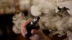 A man holds an electronic cigarette as he vapes at a Vape Shop in Monterrey, Mexico