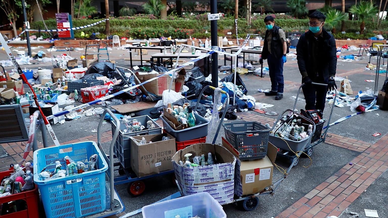 Police officers gather forensic evidence at the campus of the Polytechnic University (PolyU) in Hong Kong