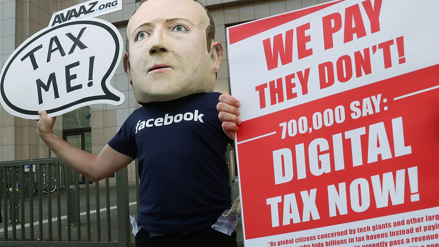 FILE PHOTO An activist wearing a mask depicting Facebook's CEO Mark Zuckerberg demonstrates during the European Union finance ministers meeting in Brussels, 2018