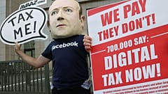 FILE PHOTO An activist wearing a mask depicting Facebook's CEO Mark Zuckerberg demonstrates during the European Union finance ministers meeting in Brussels, 2018