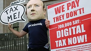 FILE PHOTO An activist wearing a mask depicting Facebook's CEO Mark Zuckerberg demonstrates during the European Union finance ministers meeting in Brussels, 2018