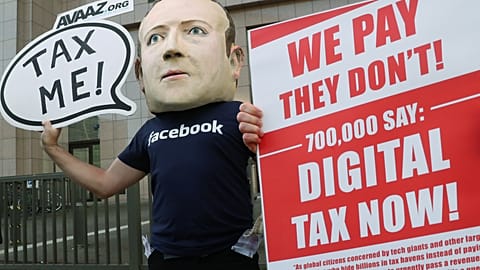 FILE PHOTO An activist wearing a mask depicting Facebook's CEO Mark Zuckerberg demonstrates during the European Union finance ministers meeting in Brussels, 2018