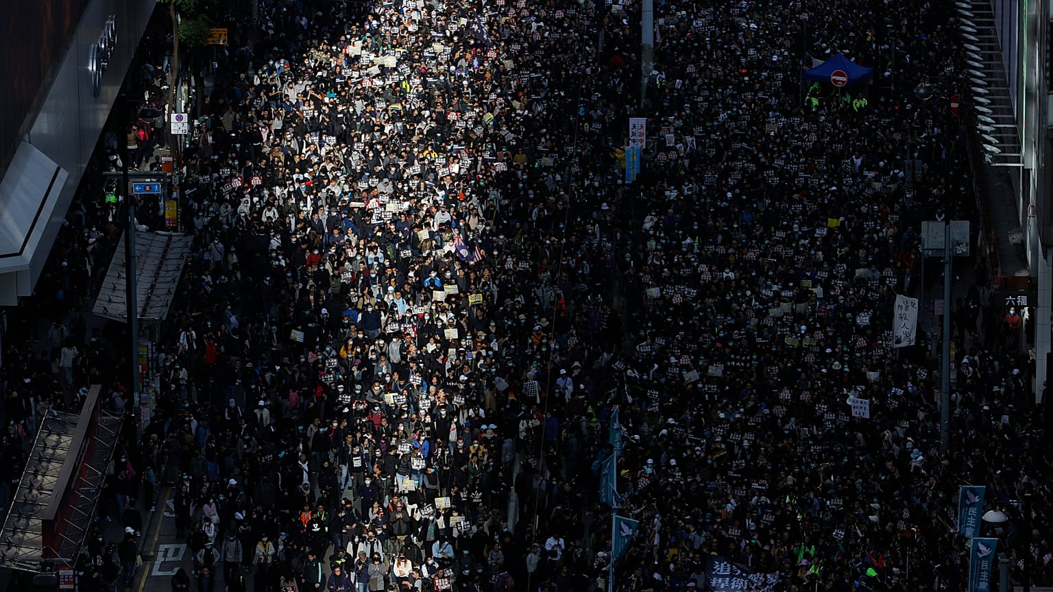 Pro-democracy protesters march on a street in Hong Kong, Sunday, Dec. 8, 2019. 