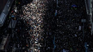 Pro-democracy protesters march on a street in Hong Kong, Sunday, Dec. 8, 2019. 