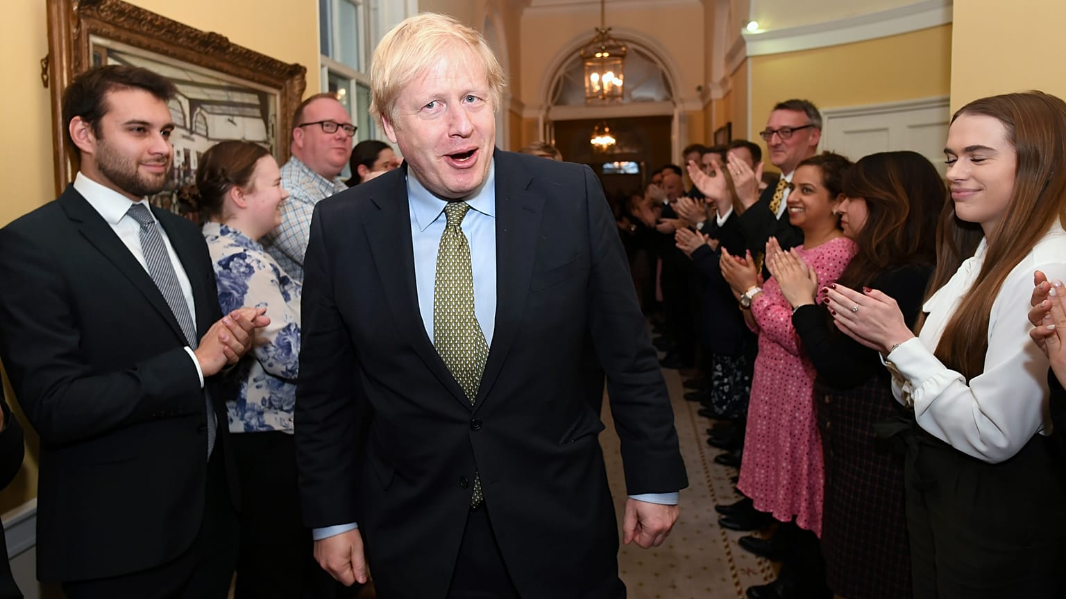 Britain's Prime Minister Boris Johnson is greeted by staff as he arrives back at Downing Street, in London, Britain December 13, 2019. 