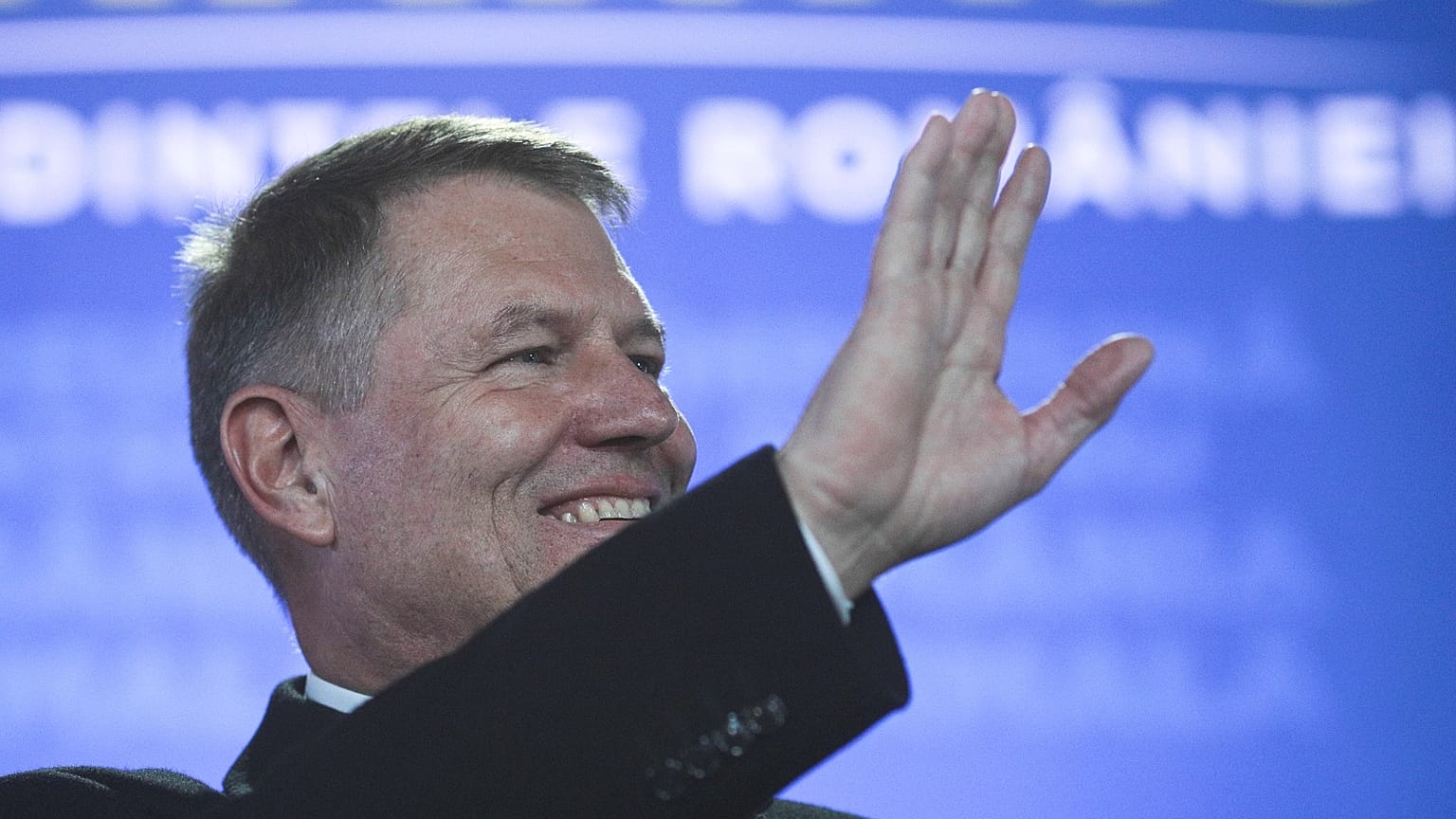 Incumbent candidate Klaus Iohannis reacts after receiving the first exit poll results following the second round of a presidential election in Bucharest, Romania