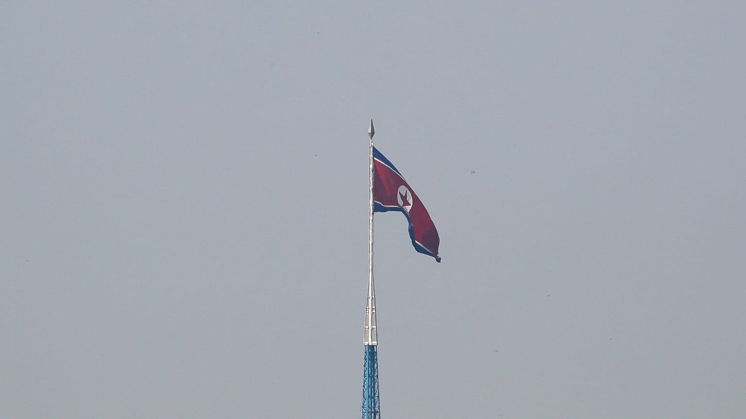 A North Korean flag flutters on top of a tower at North Korea's propaganda village of Gijungdong, as seen from Paju, South Korea, September 30, 2019.