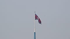 A North Korean flag flutters on top of a tower at North Korea's propaganda village of Gijungdong, as seen from Paju, South Korea, September 30, 2019.