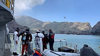 Members of a dive squad conduct a search during a recovery operation around White Island