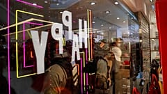 Police officers are seen through a shop window as they detain a demonstrator, during an anti-government protest inside a mall, in Hong Kong, China December 15, 2019. 