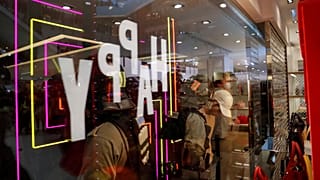 Police officers are seen through a shop window as they detain a demonstrator, during an anti-government protest inside a mall, in Hong Kong, China December 15, 2019. 
