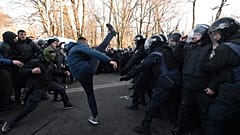 Activists of Ukrainian far-right movements clash with police forces during a protest against land sale reform in front of the Parliament in Kiev on December 17, 2019.