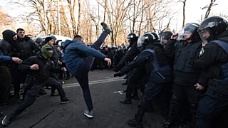 Activists of Ukrainian far-right movements clash with police forces during a protest against land sale reform in front of the Parliament in Kiev on December 17, 2019.