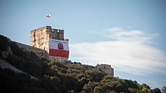A Gibraltar flag reading "self determination is our right" is displayed on a castle and old jail during National Day celebrations in the British territory of Gibraltar in 2019