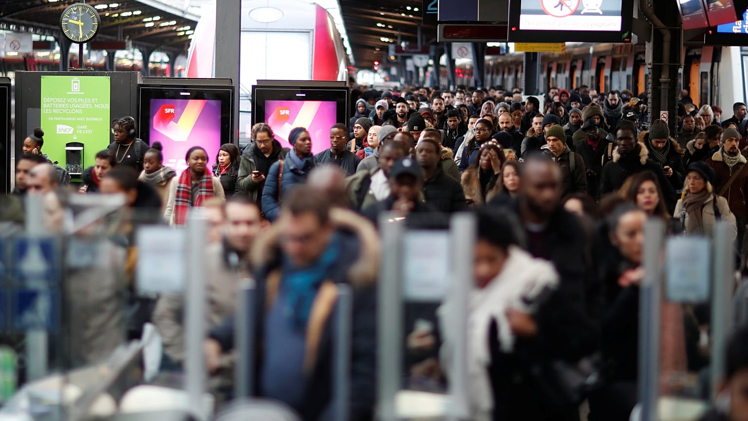 Commuters walk on a platform at Gare de l'Est train station during a strike by all unions of French SNCF and the Paris transport network (RATP) in Paris 