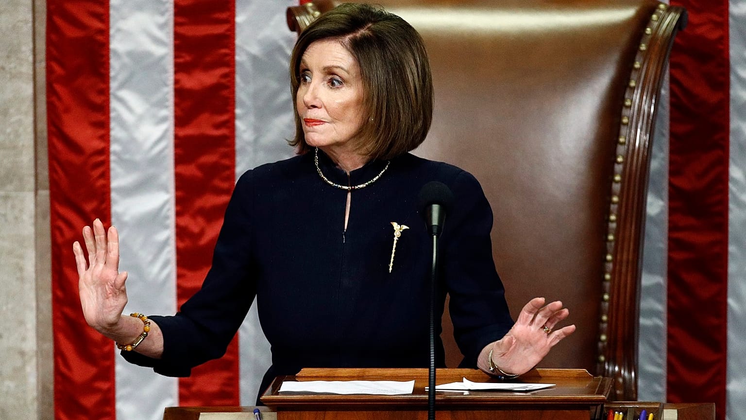 House Speaker Nancy Pelosi of Calif., gestures for Democrats to stop talking during a vote on the articles of impeachment against President Donald Trump, Dec. 18, 2019